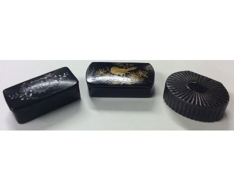 An MOP hinged top snuff box together with two others. Est. £20 - £30.