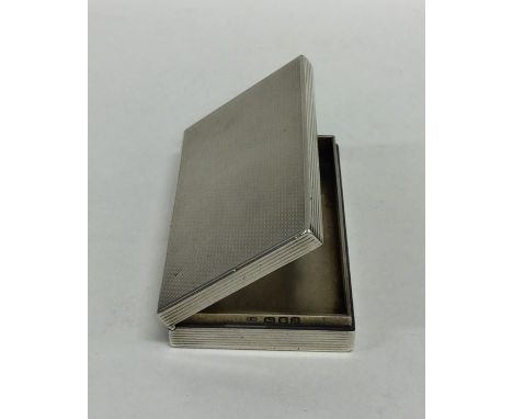 A good quality silver engine turned snuff box with hinged top to reeded border. London. By FB. Est. £30 - £40.