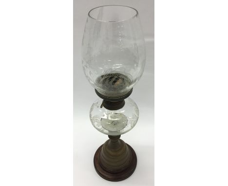 An etched glass and brass mounted oil lamp. Est. £30 - £40.