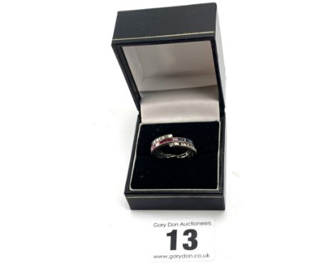 Silver triple ring with red, blue and white stones (some missing), size N