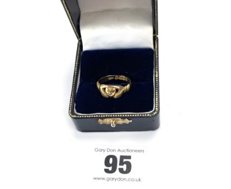 18k gold ring with hands clasping heart design and tiny centre diamond, size O, w: 3.4 gms