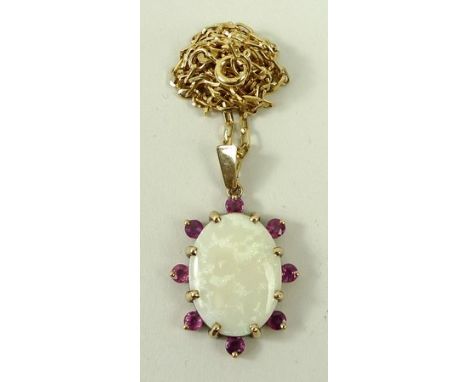 A 9ct gold and opal pendant in a surround of rubies, on a 9ct gold oval link chain, opal 20 by 15mm, 9.7g.