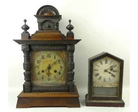 An oak cased bracket clock with brass dial, Roman numerals, striking, 17 by 9 by 24cm, and an early 20th century German mante