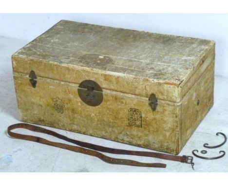 A Chinese pig skin trunk with brass fittings and brightly coloured interior, 72 by 42 by 31cm high.
