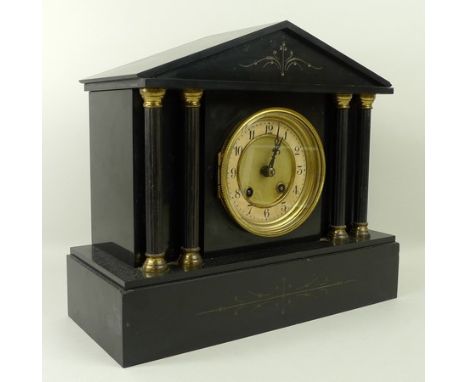 A black slate mantle clock, late 19th century, of architectural form, the engraved pediment raised above four columns flankin