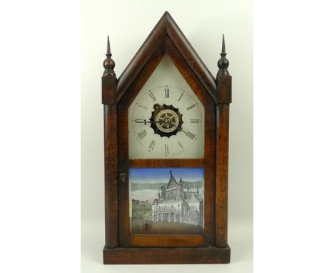 An American wooden cased mantel clock, enamel dial bearing Roman numerals, with particularly exposed wood, glass panel door d