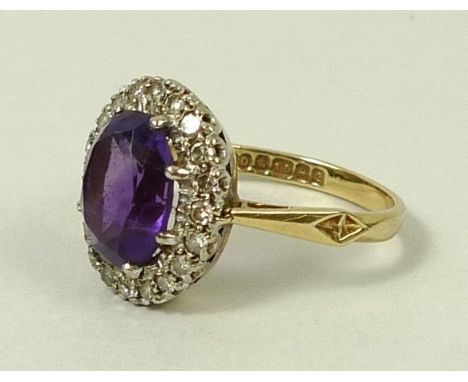 An 18ct gold and amethyst ring in a surround of diamonds, approximately 0.3cts, size M, 4.3g. 