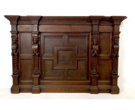 A 17th century and later section of overmantle carved oak panelling, the 17th century caryatids flanking a 19th century geome