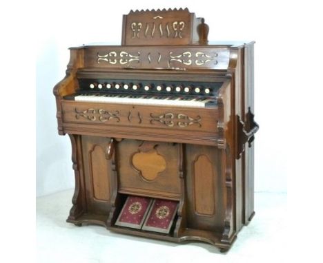 A Moore and Moore harmonium organ, foot pump operated, in good working order, together with a stool, 122 by 54 by 136cm high.