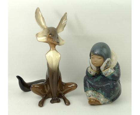 A Lladro matt porcelain figure modelled as a seated Eskimo, 17cm high, and a Magen Renaker porcelain figure of a seated Wiley