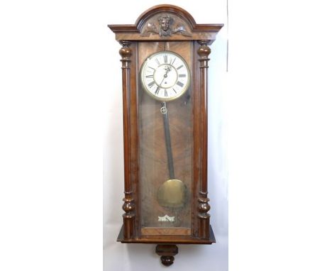 A Vienna regulator walnut cased wall clock, late 19th century, cream enamel dial, the chapter ring bearing Roman numerals, su