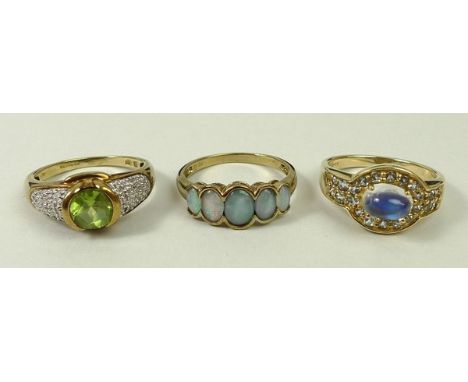 A 9ct gold and peridot ring with diamond set shoulders, size R, 9ct gold and five stone opal doublet ring, size R, and a 9ct 