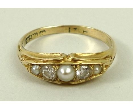 An 18ct gold diamond and pearl ring, of two diamonds and three pearls in a channel setting, size O, 3.2g total weight. 