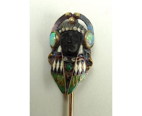 An Art Deco, Egyptian revival enamel and jewelled stick pin, in the style of Carlo Guiliano, the setting in the form of a Pha