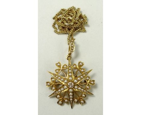 A 15ct gold, pearl and diamond pendant of starburst form, with a central 1/16ct diamond, the six pearl set points joined by p