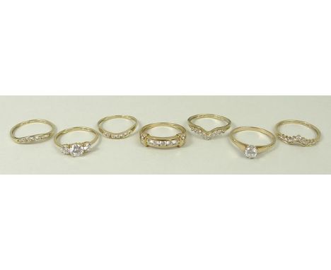 A 14ct gold and zircon three stone ring, size P, two matching half eternity rings, a 14ct gold and zircon solitaire ring, siz