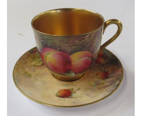 A Royal Worcester cabinet cup and saucer, decorated with fruit to a mossy background, the cup by E Phillips and the saucer by