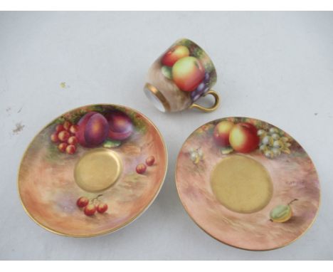 Three pieces of Royal Worcester, a cup and two saucers, all decorated with fruit to a mossy background by Aryton and Townsend