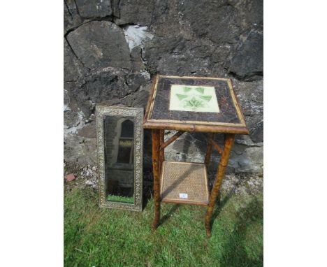 An Arts and Crafts style bamboo jardiniere stand, with inset tile, together with a metal framed mirror