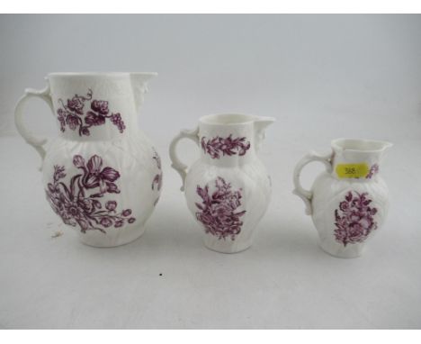 A set of three graduated Royal Worcester jugs decorated with purple flowers to a white ground&nbsp;