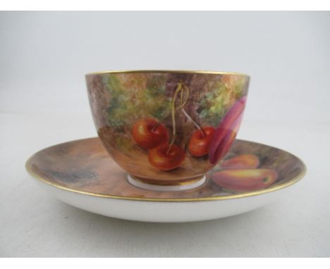 A Royal Worcester cup and saucer, the exterior of the cup and the saucer decorated with fruit to a mossy background by Freema