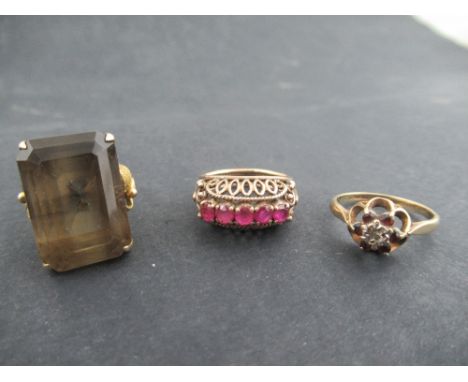 A yellow gold five stone ruby ring, in basket mount, unmarked, a gold ring set with an emerald cut smoky quartz stamped 18k a