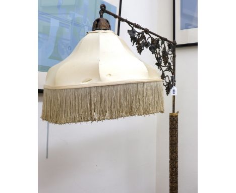 A Florentine giltwood column standard lamp, early 20th century, the cylindrical pillar and scrolled tripod base leafy scroll 