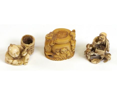 A group of three ivory netsuke, 19th/20th century, comprising, a man seated beside a basket, a trinket seller standing with t