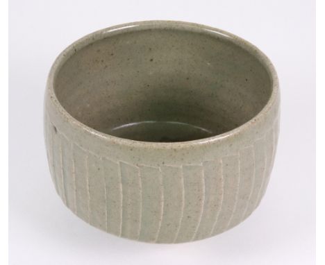 David Leach (1911 - 2005), Lowerdown Pottery, a stoneware cut sided bowl on circular foot in celadon glaze, impressed seal ma