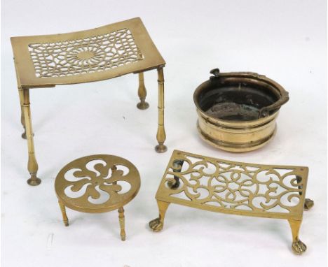 A late 18th/early 19th century brass footman or trivet, the curved rectangular pierced top, on ring turned baluster legs, 27.