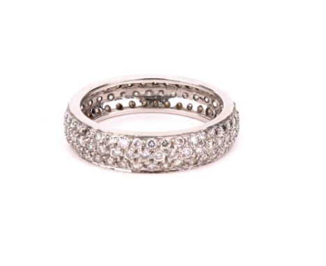 A diamond eternity ring, pave-set with three rows of small brilliant-cut diamonds in white metal, stamped '750', ring size M,