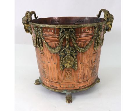 A Louis XV style copper and brass jardiniere, late 19th century, slightly tapering circular, with rams mask side handles and 