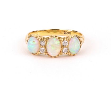 A three stone cabochon opal and diamond carved half hoop ring, the oval cabochons divided by two pairs of old-cut diamonds, s