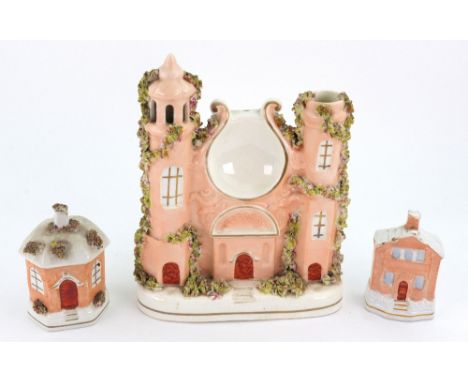A Staffordshire pottery pocket watch stand in the form of a castle, 21.5cm high, a similar hexagonal cottage money box and an