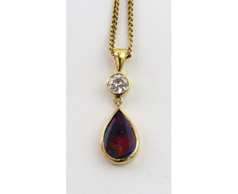 A black opal and diamond pendant on a chain, the round brilliant diamond approx. 0.30cts above a pendent pear-shaped opal set