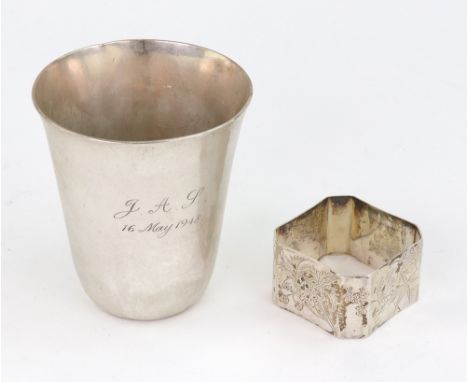 A German silver beaker, Hessenberg, Frankfurt, detailed 800, 8.5cm high, inscribed and a Victorian silver napkin ring, Edward