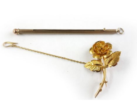 A 9ct yellow gold swizzle stick by Sampson Mordan & Co., 3.6g, and a yellow gold rose brooch (unmarked) 5.3g. (2).