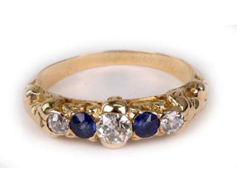 An early 20th century gold, sapphire and diamond seven stone ring, circa 1928, the three graduated old-cut diamonds approx. 0