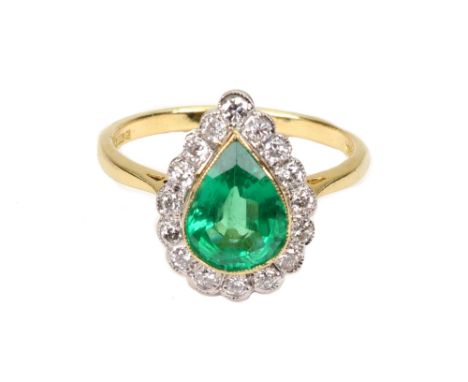 A modern 18ct gold, emerald and diamond drop-shaped cluster ring, centred with a pear-shaped emerald approx. 1.75cts, rub-ove