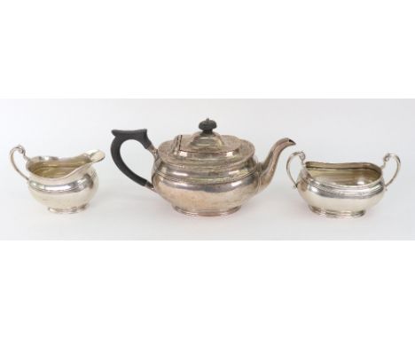 A George III style silver three-piece tea service, Charles Clement Pilling retailed by Harrods, Sheffield 1919, rounded recta