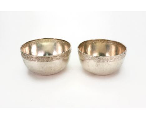 Two Chinese Export circular bowls, circa 1900, with scroll decorated upper friezes on a textured ground, 11.5 & 12cm diameter