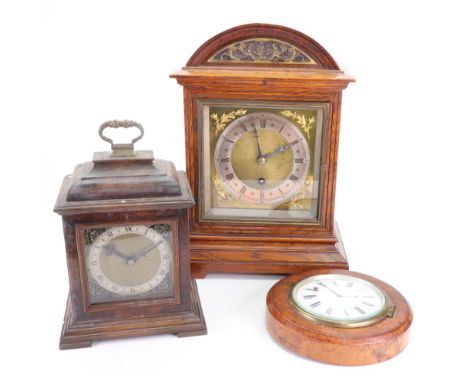 An Edwardian gilt metal mounted oak bracket timepiece, with arched top, the brass dial with silvered chapter ring, 31cm high,