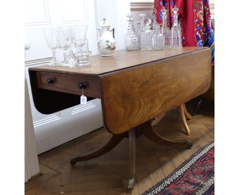 A George IV mahogany breakfast table, with hinged drop leaves, end drawer, on a ring turned pillar and quadripartite base, 10