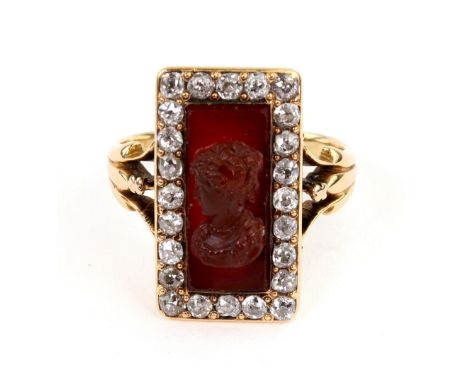 An early 20th century gold, diamond and hardstone cameo ring, the rectangular cameo carved with a female profile within an ol