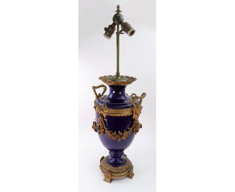 A French blue glazed porcelain gilt metal mounted table lamp, first half 20th century, of classical vase form, the sides appl