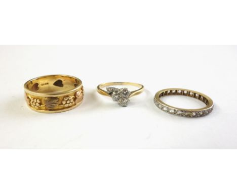 A 14ct three-colour gold wide band ring cast with fruiting vines, stamped '14k' and import mark London 1988, 5.2g, a gold and