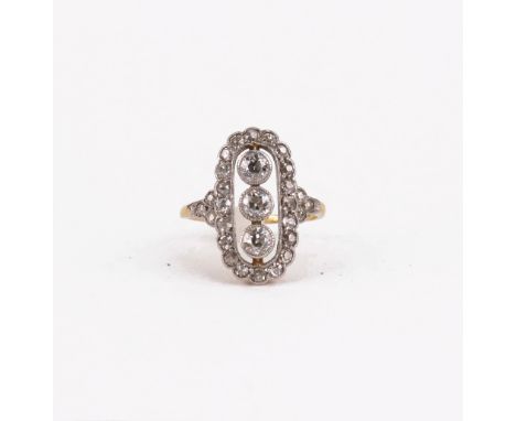 An early 20th century gold and diamond cluster ring, with three central old-cut diamonds within an open surround and a small 