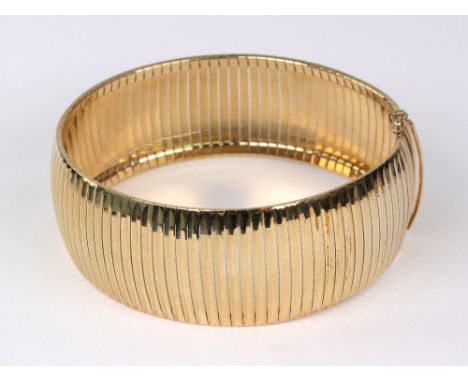 An Italian 9ct gold broad bracelet, approx. 25mm wide, post 2000 import marks for Sheffield, 34.4g.