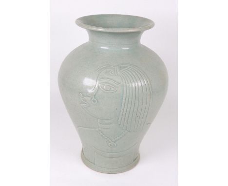 A large baluster stoneware vase, possibly by René Buthaud, carved in relief with stylised profile of African women, in all-ov
