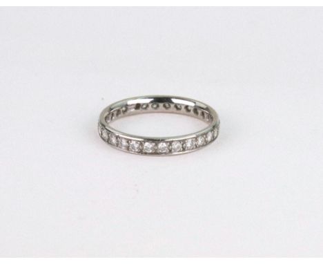 A diamond eternity ring, the 28 brilliant diamonds approx. 0.56cts total, set in white, stamped '950', ring size P, 4g gross,